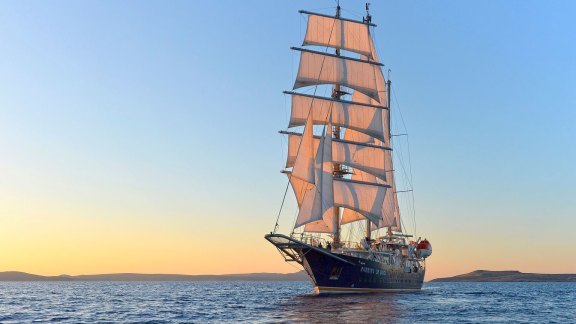 Luxury Sailing Yacht Running on Waves under full sail