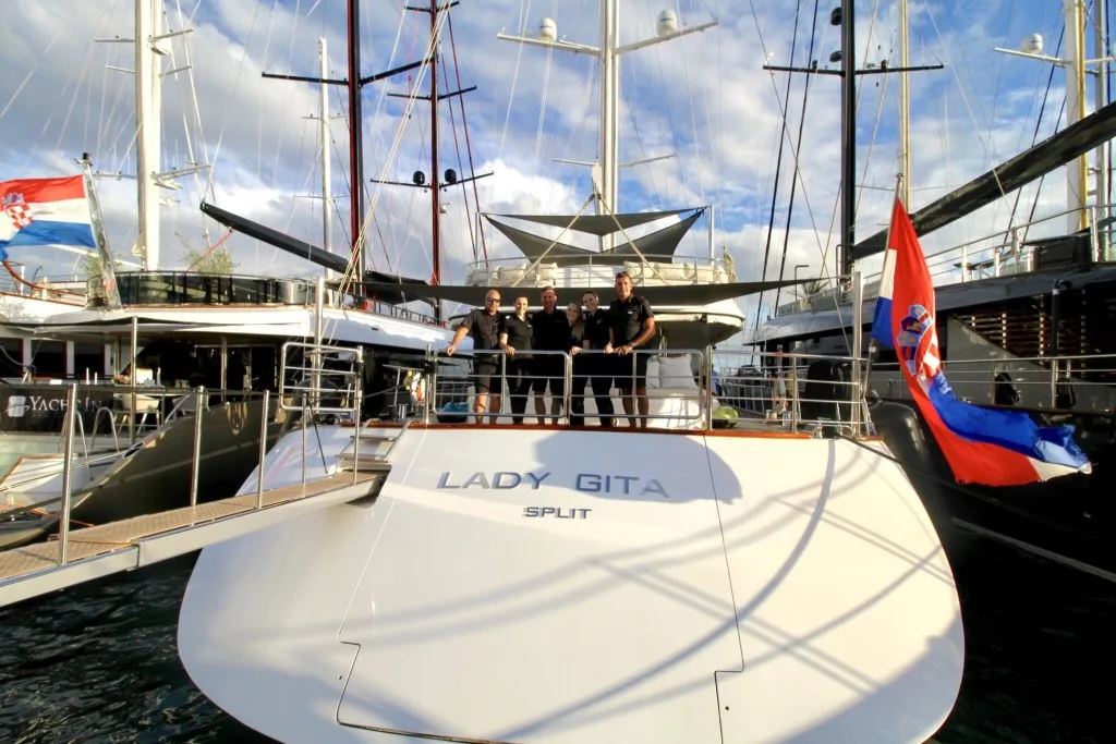 Crew standing at the stern of Luxury Motor Sailor Lady Gita