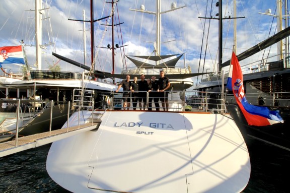 Crew standing at the stern of Luxury Motor Sailor Lady Gita