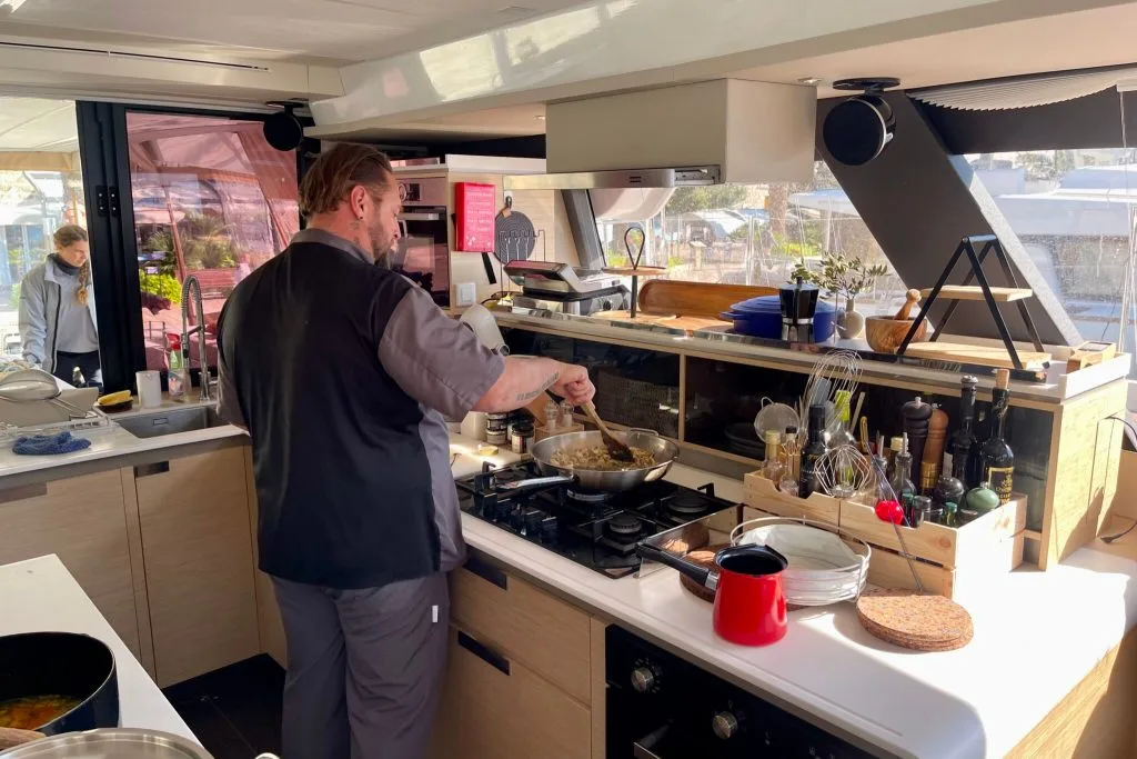Chef Igor cooking in the galley of charter catamaran FLORAMYE in Croatia