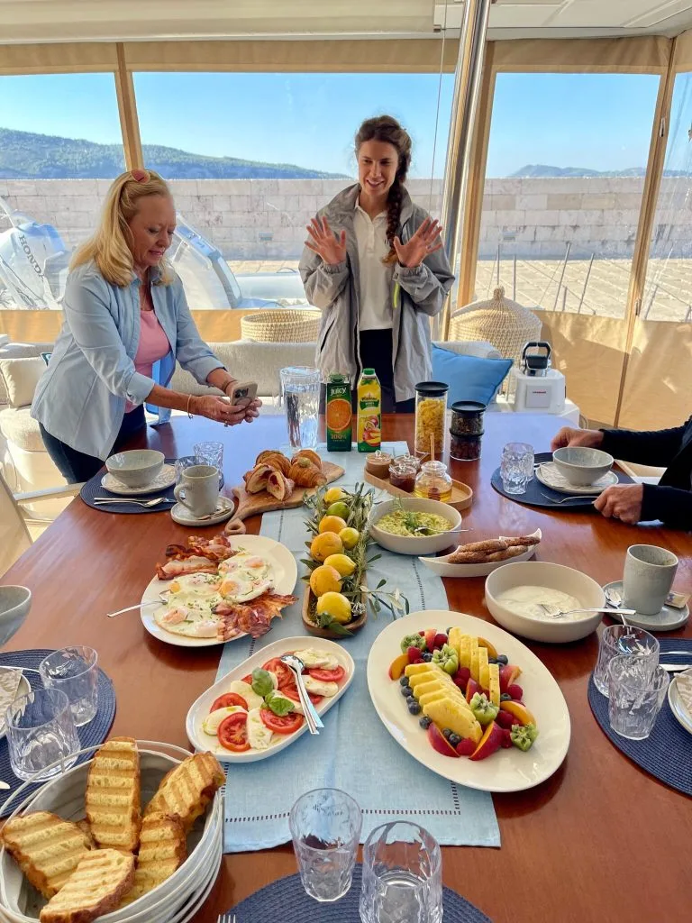 Stewardess Nadja served breakfast onnboard catamaran FLORAMYE