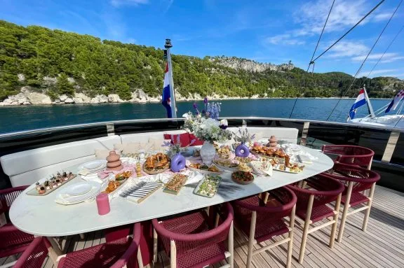 Lunch set for the whole family on the sundeck onboard luxury motorsailer REPOSADO, anchored outside of Split on the Dalmatian Coast