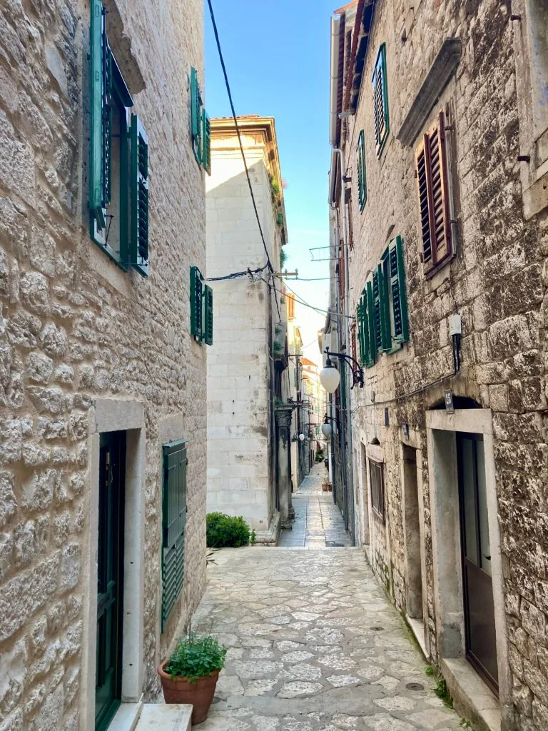 Narrow cobbled lane between stone houses in Šibenik old town
