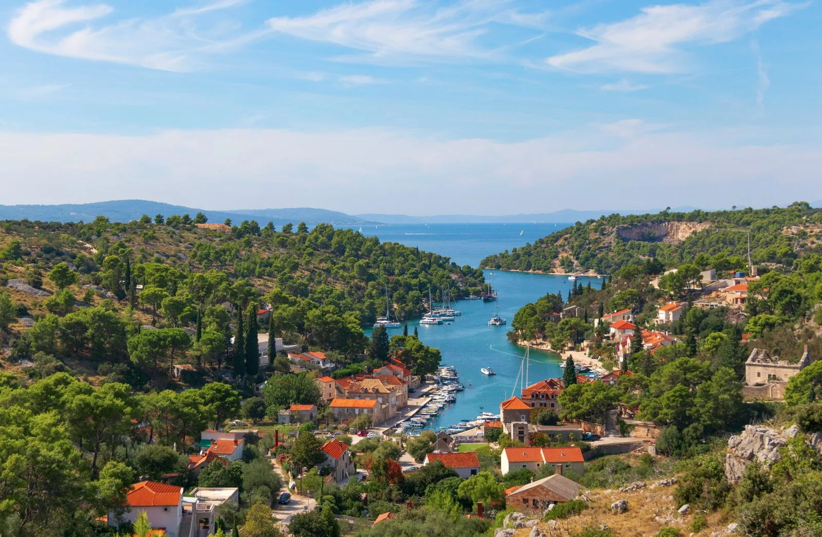 Bobovišća na Moru bay on Brač, with boats and wooded shores