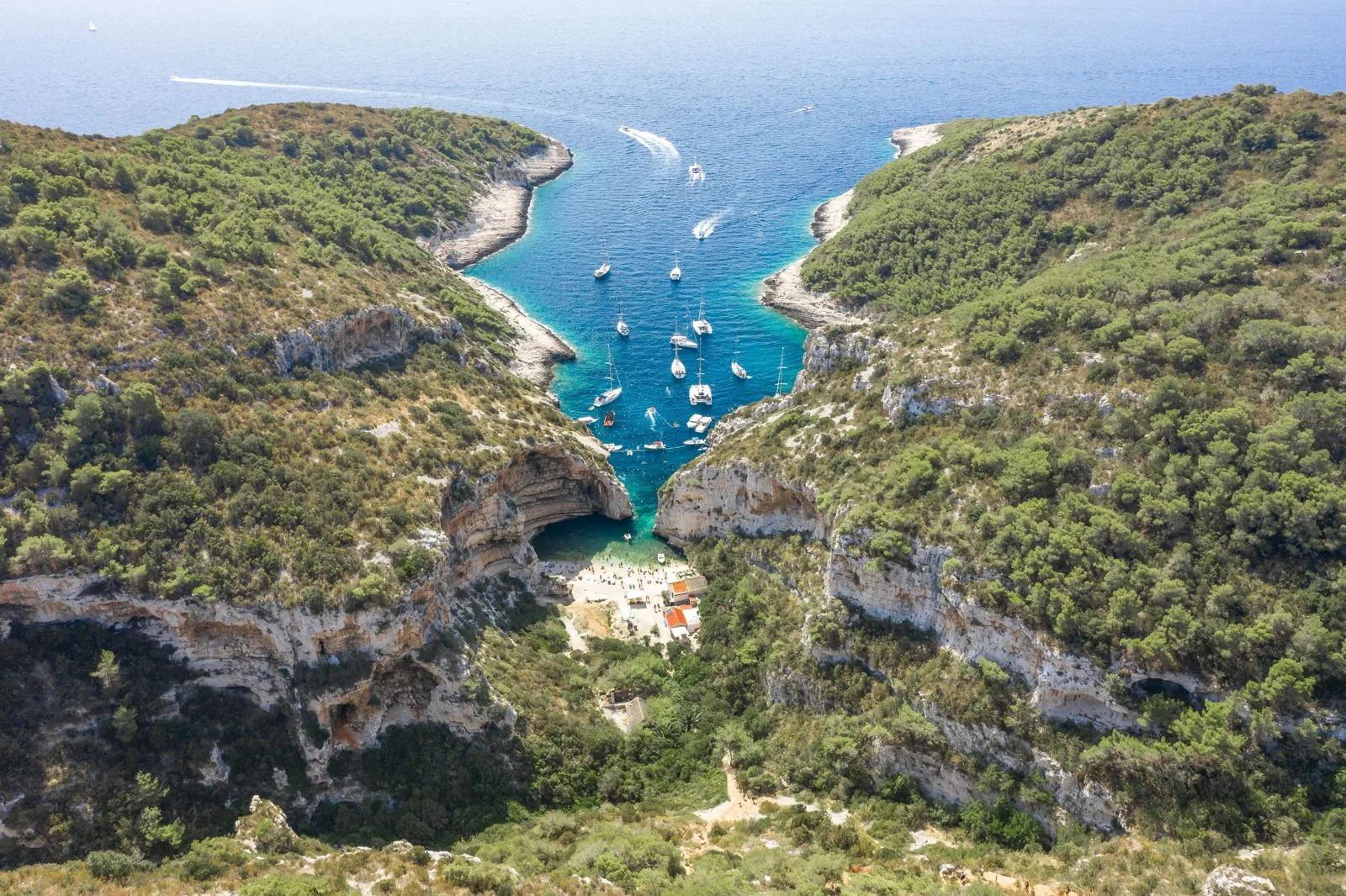 Aerial view of Stiniva cove and its narrow entrance on Vis