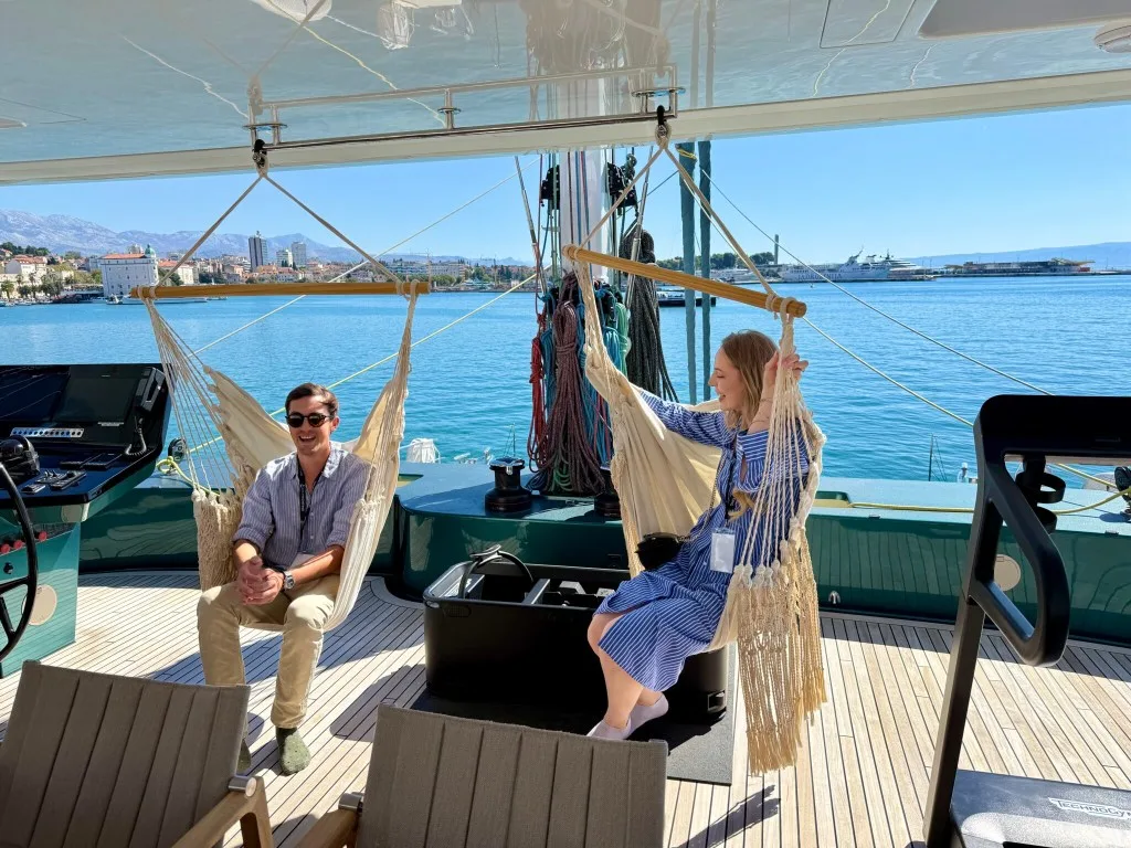 Miles and Carina in hanging chairs onboard catamaran MIDORI at the CROYA Yacht Show 2026