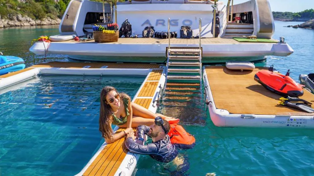 The swim platform and inflatable sea pool at the stern of motor yacht ARGO with toys laid out, from the yacht's own photography.