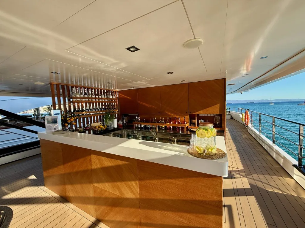 The cocktail bar on the bridge deck of motor yacht ARGO, set with citrus and bottles, Split, September 2026.