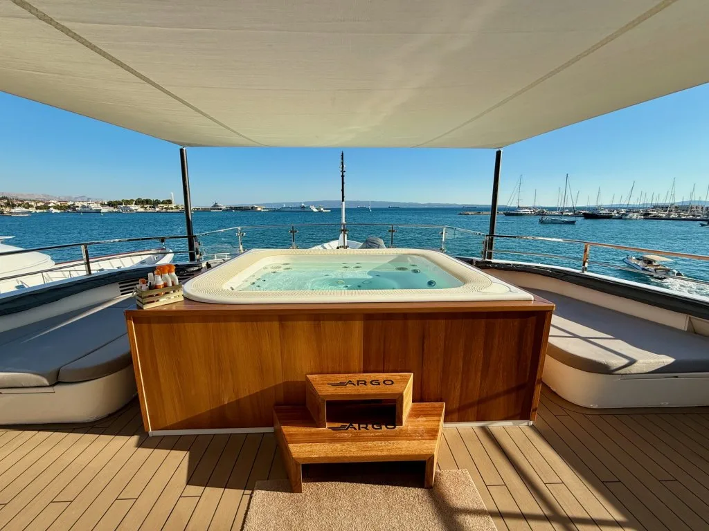 The forward jacuzzi on the bridge deck of motor yacht ARGO with Split harbor beyond, September 2026.