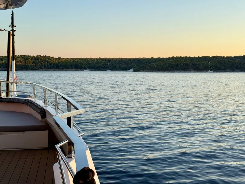 The coast of Brac at golden hour seen from the bridge deck of motor yacht ARGO near Milna, Croatia, September 2026.