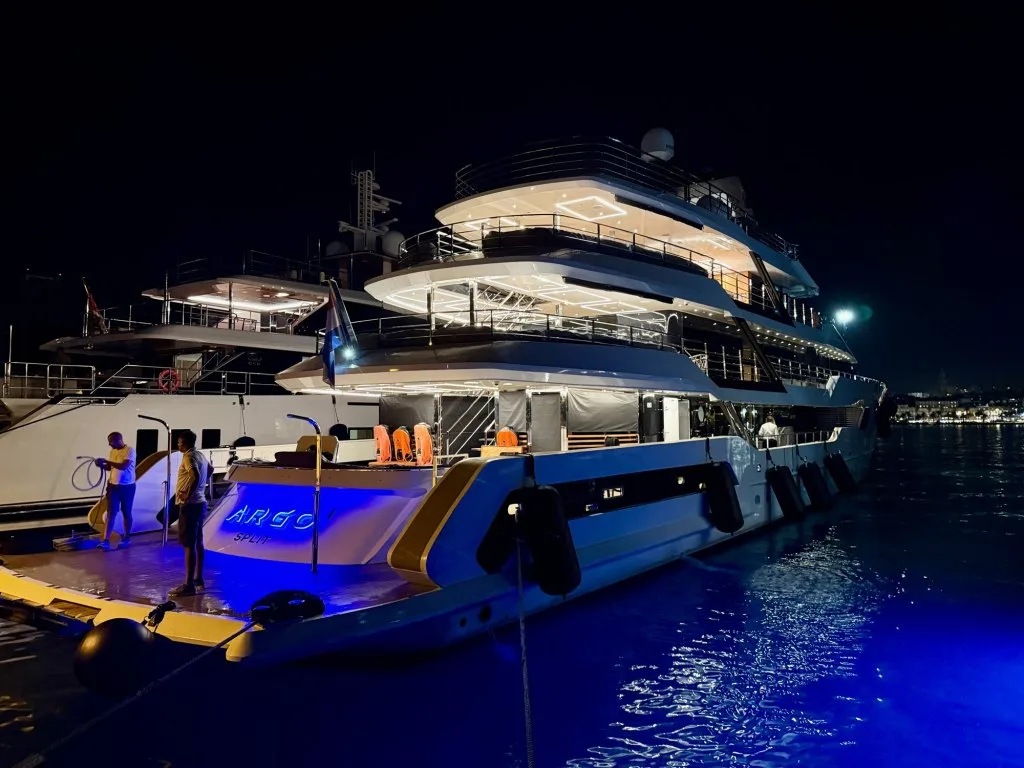 Motor yacht ARGO lit up at night on the water off Split, Croatia, September 2026.