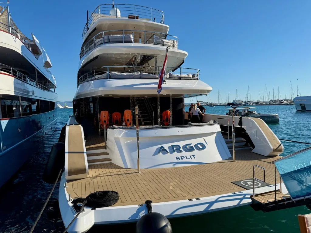 The stern of motor yacht ARGO alongside at ACI Marina Split during the CROYA Yacht Charter Show, with her name on the transom, September 2026.