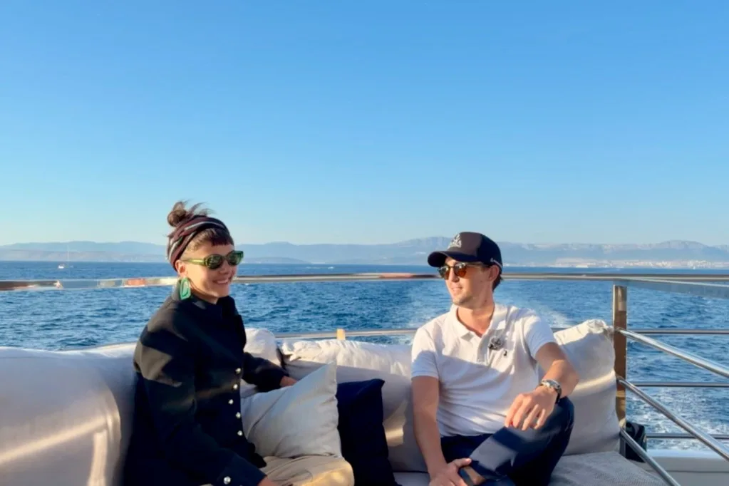 DMA Yachting's Klara Braga Jakobsen and broker Miles Froelicher sitting on the deck of motor yacht ARGO underway off Brač, Croatia, September 2026.