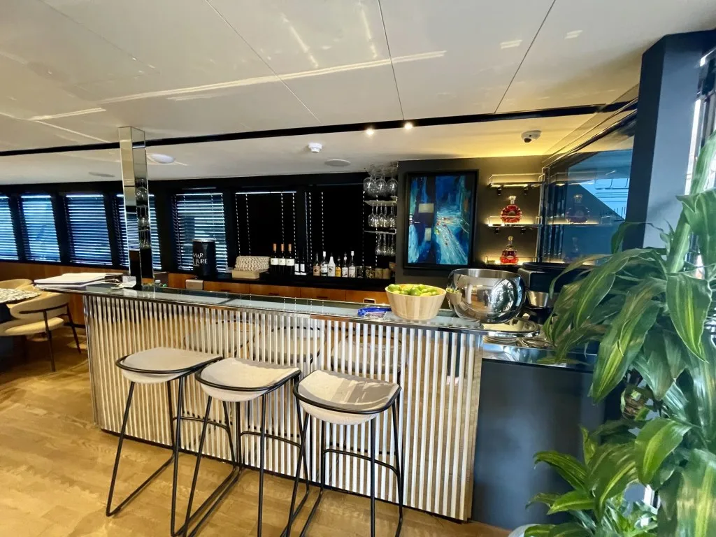 MARALLURE main saloon bar with its fluted front and bar stools