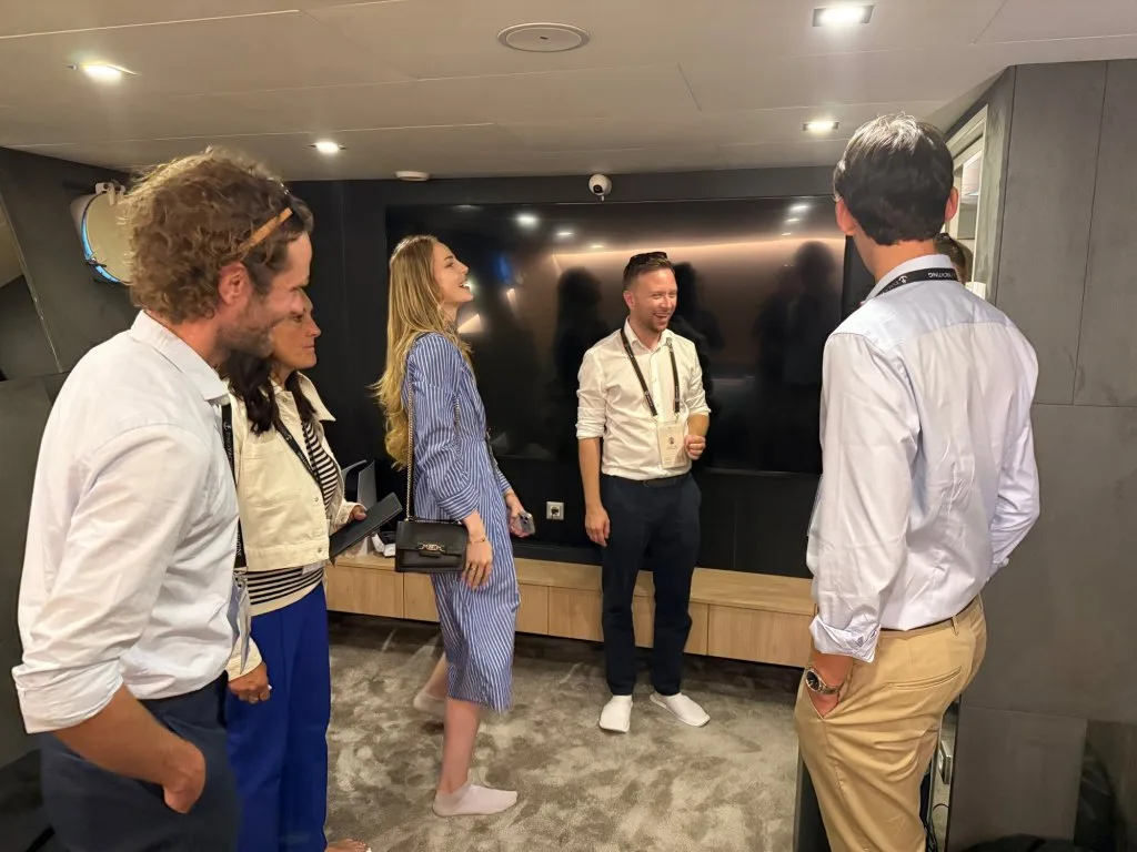 The cinema room on motor yacht OHANA with its wide screen, photographed during the CROYA show walkthrough with brokers touring the room, September 2026.