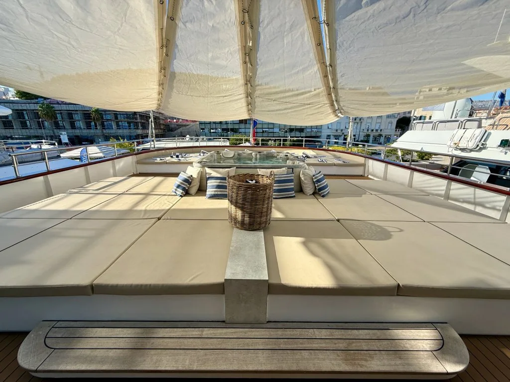 The sun deck of motor yacht OHANA with sunpads and the lounge around the jacuzzi under shade sails, September 2026.