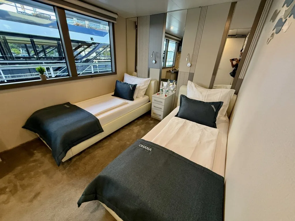 A twin guest cabin on motor yacht OHANA with two single beds and a window, September 2026.