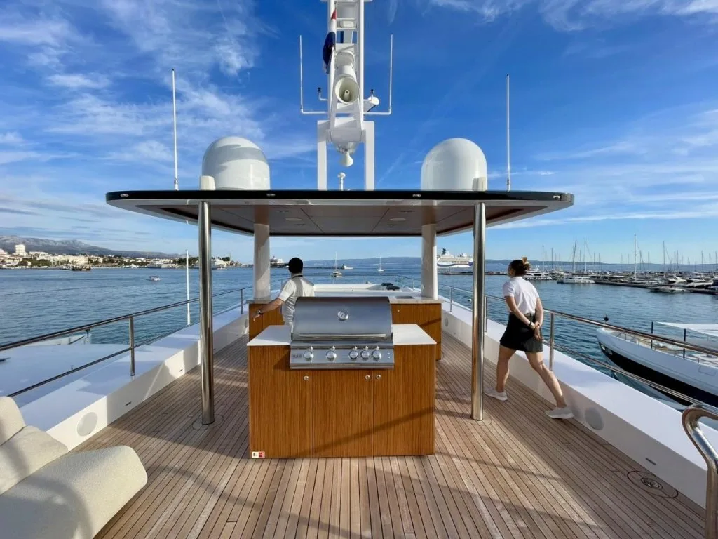 The sun deck of motor yacht RENATA with its bar and barbecue under the hardtop, September 2026.