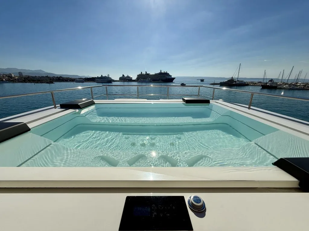 The jacuzzi on the sun deck of motor yacht RENATA with Split harbor behind, September 2026.