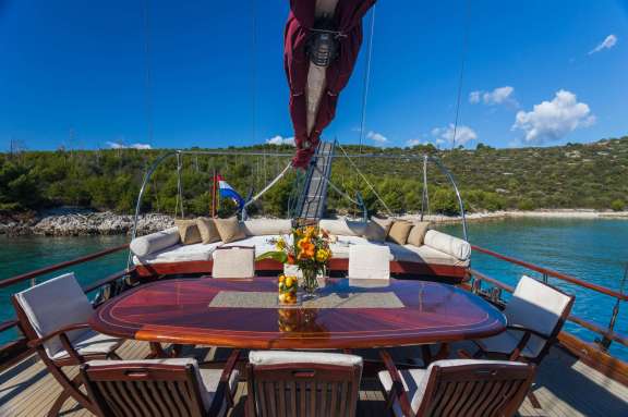 Nostra Vita's aft dining table and a full beam sofa